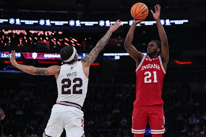 Indiana Hoosiers forward Mackenzie Mgbako (21) shoots the ball as Louisville Cardinals guard Tre White (22) defends during the second half at Madison Square Garden.